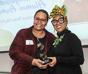 Luella Loiselle presenting Donna Bess Myers with an award